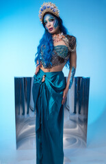 Attractive woman in a blue mermaid costume. Fantasy studio portrait of a mermaid model