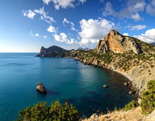 Obraz premium Coastal landscape featuring clear blue sea, dramatic cliffs, and sky