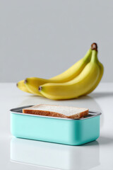 Preparing a healthy lunchbox with slice of bread and bananas