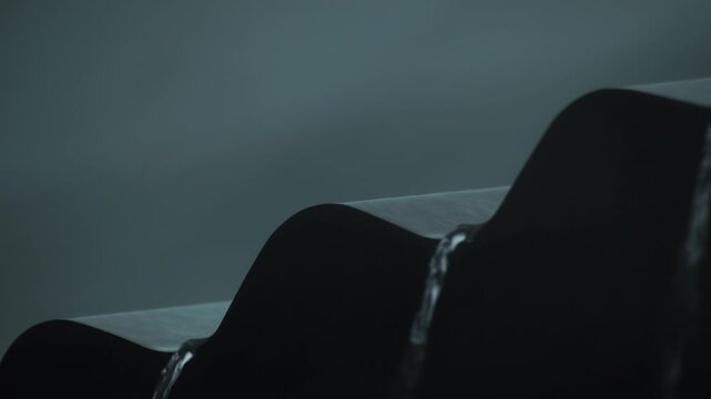 Heavy rain is falling noisily from the balcony roof.