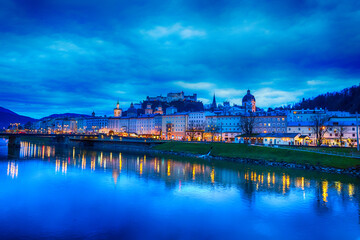 Fototapeta premium Evening twilight view of Salzburg across Salzach river in Austria