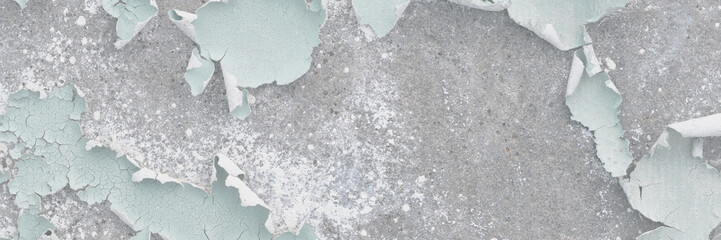 Peeling paint on the wall. Old concrete wall with cracked flaking paint. Weathered rough painted surface with patterns of cracks and peeling. High resolution texture for background and design. Closeup