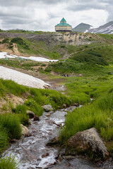 View of the hotel in the mountain valley. Summer mountain landscape. Travel and tourism on the Kamchatka Peninsula. Beautiful nature of Siberia and the Russian Far East. Kamchatka Territory, Russia.