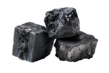 Pile of rough, dark, shiny charcoal pieces on black ground