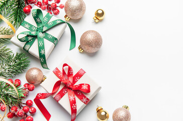 Christmas gifts decorations with holly and ornaments on white