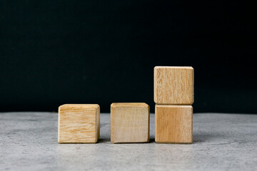 Four empty wooden blocks on a table with empty space for your text, letters or numbers.
