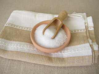 Epsom bath salt in a ceramic bowl on a towel
