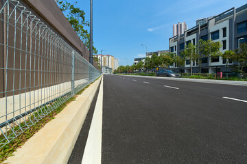 Asphalt road through modern residential townhouses area