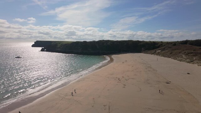 Summertime establishing shot of Barafundle Bay Beach on the Pembrokeshire coast, Wales.