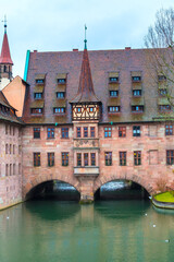 Nuremberg, Germany Holy Spirit Hospital or Heilig Geist Spital over Pegnitz River in the Old City