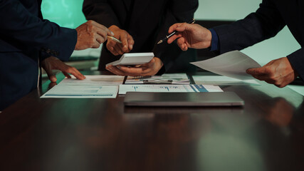 Business professionals closely review a balance sheet and digital Global Investment Portfolio data, pointing to key figures, indicating strategic financial planning and rigorous cash flow management.