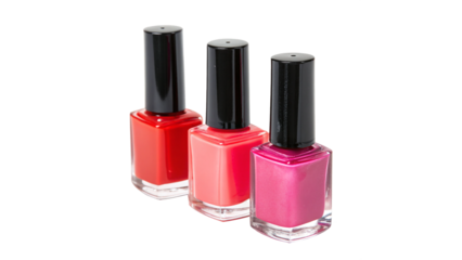 Bright and colorful nail polish bottles arranged in a row on a white background showcasing vivid shades of red and pink