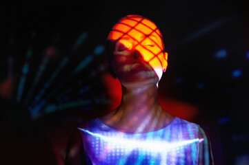 Surreal portrait with neon light projections and virtual reality concept