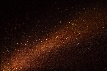 Subtle diagonal illumination reveals fine grain of brown surface, golden particles shimmer delicately creating layered depth and moody visual atmosphere