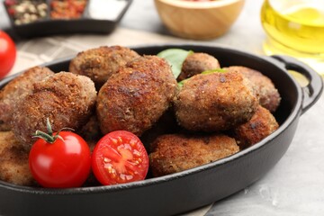 Tasty meat patties served on grey table, closeup