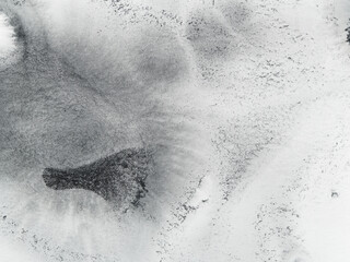 Soft watercolor pigment spreads naturally across the rough surface, creating subtle gradients of light and shadow. The texture of paper enhances every delicate transition.