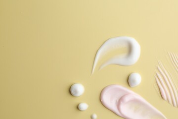 Samples of cosmetic product on beige background, flat lay. Space for text