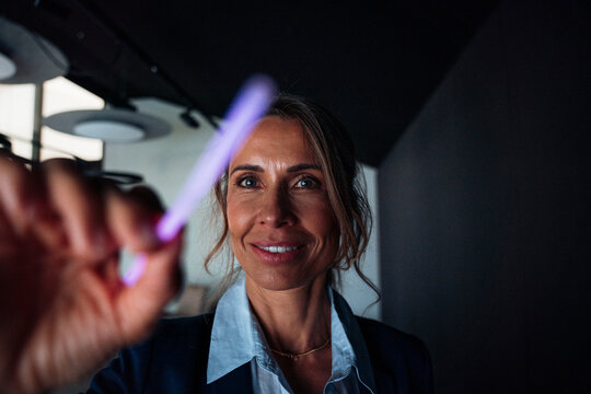 Businesswoman interacting with touchscreen in modern meeting room