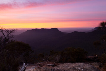 Dawn sunrise over dark mountains