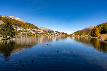 The village and lake of St. Moritz in autumn, with the trees turning color. Engadine, Switzerland.