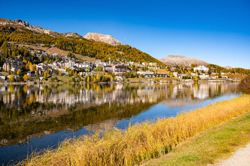 The village and lake of St. Moritz in autumn, with the trees turning color. Engadine, Switzerland.