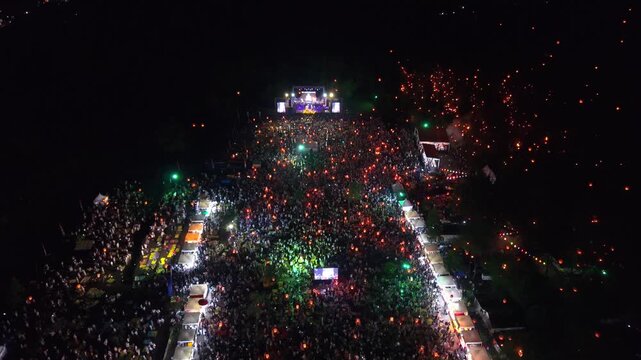 Aerial view of the vibrant Parangtritis Lantern Festival, with a sea of people holding glowing lanterns, Yogyakarta, Special Region of Yogyakarta, Indonesia.