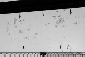 Peeling paint patterns and a wall lined with hooks