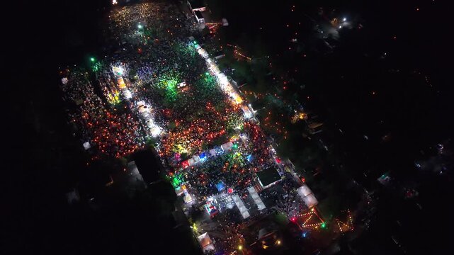 Aerial view of Parangtritis Lantern Festival, where crowds gather amidst the vibrant glow of lanterns casting a warm, inviting light, Yogyakarta, Special Region of Yogyakarta, Indonesia.