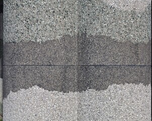 Concrete aggregate wall with bands of three colors: black, gray and green. Background and texture.