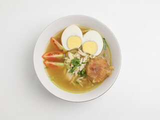 Soto Ayam or chicken soup cooked in chicken broth served with boiled egg, shredded chicken, bean sprout, fried mashed potato