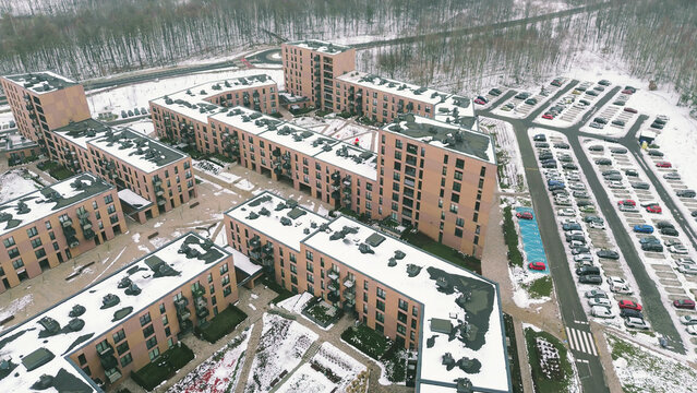 Urban apartment complex with snowy paths and roads