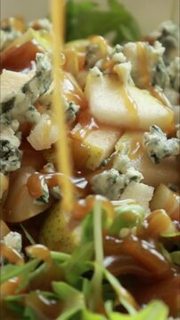 fall pear salad with blue cheese preparation close up