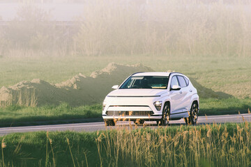 Fototapeta premium Zero emission electric car drives open road