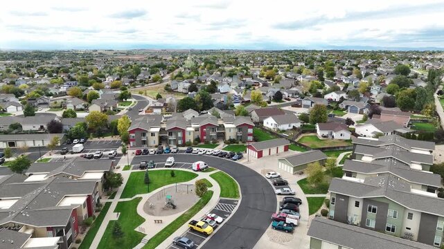 Greeley neighborhood with cars and condos establishing shot 2025