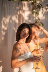 women on a picnic with bottles of water