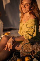A woman in a dress on a summer picnic with lemons