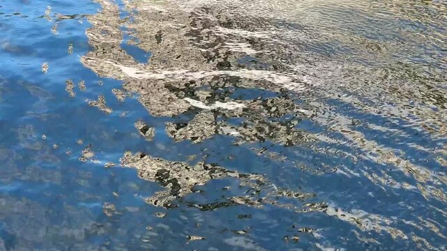 Abstract reflection of Notre Dame on rippling Seine river water.