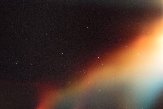 light leak overlay effect with scratch dust and blur colorful light leaks,retro noisy film texture light leak flare on black background,abstract background with colorful light,grunge old film burn