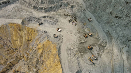 Aerial of open mine and heavy mining equipment