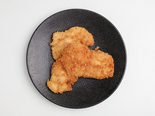 Chicken Katsu on black plate and white background