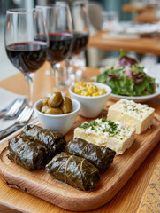Mediterranean appetizers with wine on a wooden table.