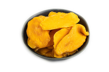 Dried Mango in blue ceramic bowl isolated on white. Side view, close up