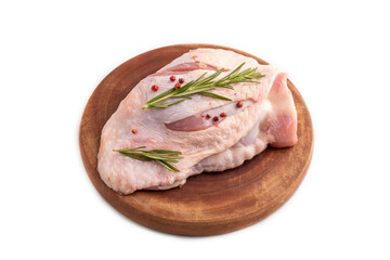 Raw Turkey Thigh with spices on cutting board isolated on white. side view, close up