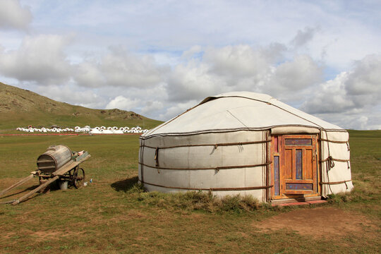 Traditional nomadic tents and a wooden wheeled horse-drawn cart in the rural areas of Ulaanbaatar, the capital of Mongolia.