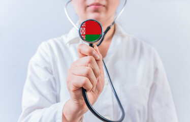 Female doctor holding stethoscope with Belarus flag. National health system of Belarus
