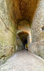 Castle of Sedan, Sedan, Rethel, Ardennes, Grand-Est, France, August, 28th, 2025, Explore a historic stone passageway leading to picturesque archways, exuding timeless character and age