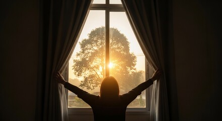 Silhouette of a person opening curtains revealing sunrise through a window framing a tree
