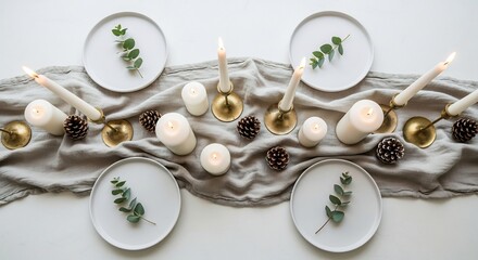 Table set with candles pinecones plates and a gray linen runner