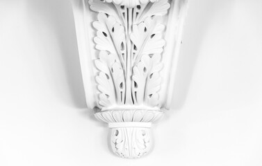 White gypsum bas-relief decoration with floral pattern. Classic wall moulding