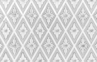 White stucco pattern over light gray backdrop. Classic ceiling moulding